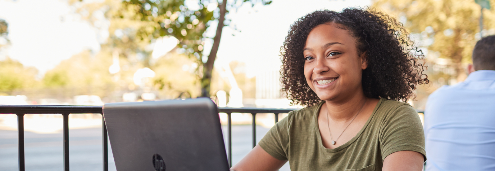 A girl sitting at a cafe on her laptop