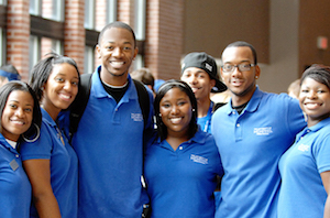 group of african american students all wearing blue shirts smiling