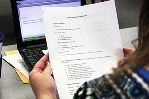 student holding sheet of paper