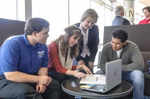 students looking at papers together