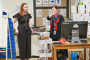 school administrator talking to teacher