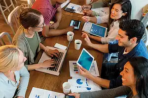 overhead shot of student group working with laptops